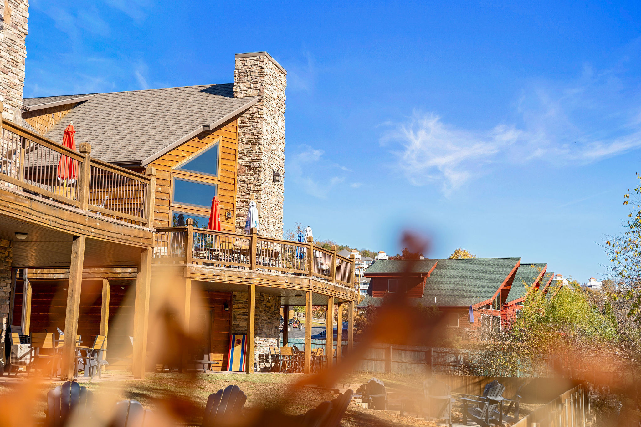 Lakestone lodge exterior with decks and autumn trees.